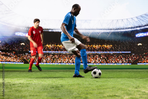 Фотография Blue soccer player controls and dribbles the ball in attack, using quick footwork to move past a red opponent during a dynamic one-on-one possession duel on the pitch in a competitive match