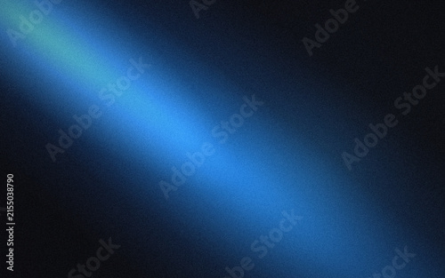 Bright blue light beam cutting diagonally through a dark black background, with a visible, grainy texture and, a soft, glowing illumination