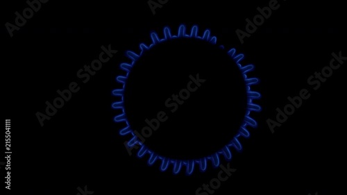 Gas stove burner igniting with blue flame in dark kitchen close up. Macro shot of gas cooker turning on with bright blue fire