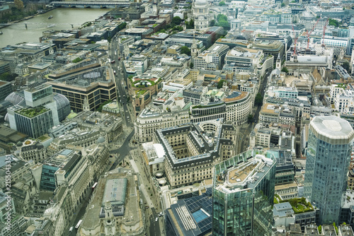 View of the dense urban landscape of the City of London featuring historic and modern architecture, intricate street patterns, and rooftops in London, England, United Kingdom.