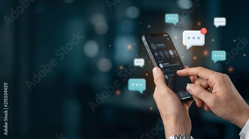 Hands using a smartphone with digital chat bubble notification icons and messaging symbols