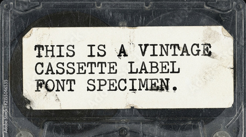 Obraz na płótnie Vintage cassette tape label font specimen on aged paper background for retro des