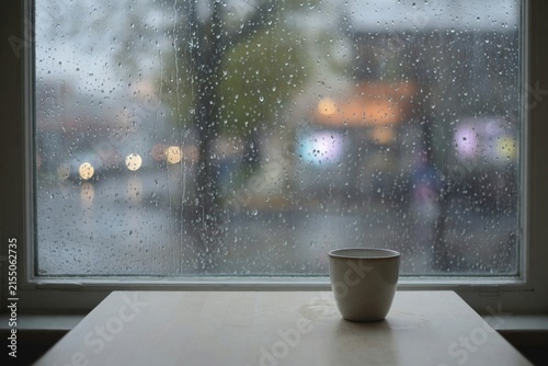 Rain window cafe table empty cup blur