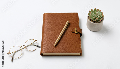 Leather notebook with pen on minimalist desk