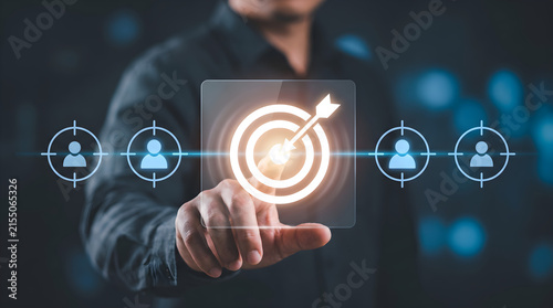 Businessman touching glowing target arrow icon aiming customer audience focus strategy for success in digital marketing business