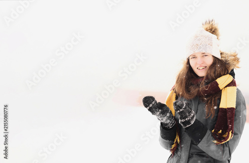 Photo of Girl Dressed in Winter Clothes During Snowfall