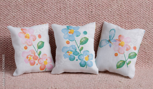 Three cushions wth colorful flowers