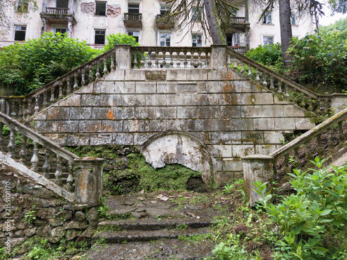 Photography Abandoned stone staircase overgrown with green vegetation in city of Akarmara, Abkhazia