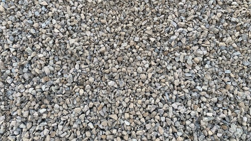Konstfotografi A pile of gravel in various sizes and brownish-gray hues, featuring a rough, natural texture suitable as a background for construction materials or road surfaces