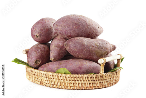 Quadro su tela Fresh Purple Sweet Potatoes in Wicker Basket - Organic Vegetables