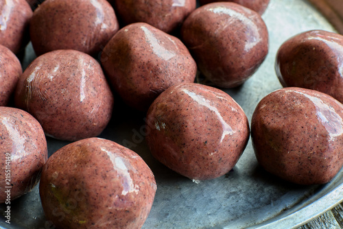 Shrimp paste balls wrapped in plastic on tray