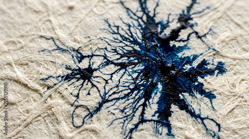 Blue neuron cells embroidered on white textured fabric art