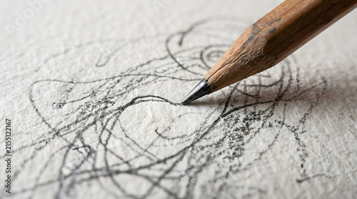 Close-up of graphite pencil tip drawing on textured paper