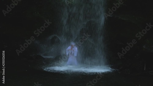 August 9 2026, Kanagawa Prefecture, Japan; man performing meditation under Yuhi no Taki waterfall in Kanagawa Prefecture.