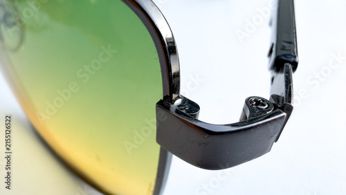 Foto Macro view of yellow tinted sunglasses frame and lens edge, optical accessory detail