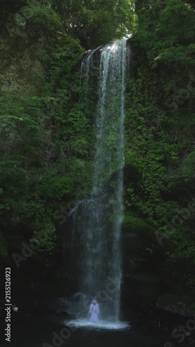 August 9 2026, Kanagawa Prefecture, Japan; man performing meditation under Yuhi no Taki waterfall in Kanagawa Prefecture.