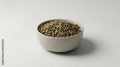 A close-up studio shot of a simple ceramic bowl filled with organic alfalfa pellet feed on a neutral background for agriculture and livestock nutrition.