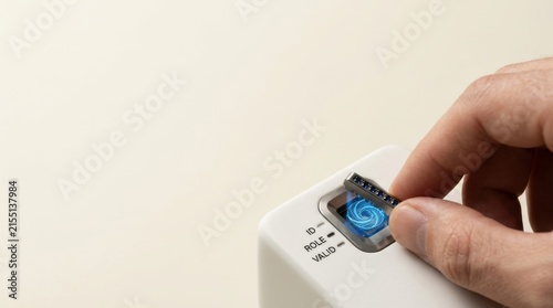 Person's hand holding a remote control symbolizing distinct verifiable identity for autonomous ai agents in action