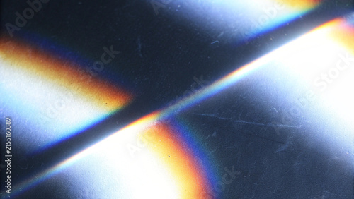 Rainbow iridescent holographic gradient with crystal prism rays, colorful light flare and sparkle, abstract retro film burn overlay for creative designs.