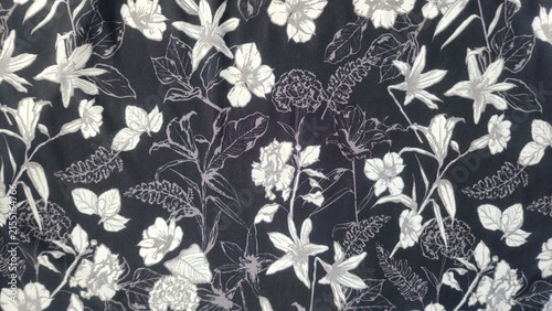 Monochromatic floral pattern with white and grey flowers and leaves on a dark background