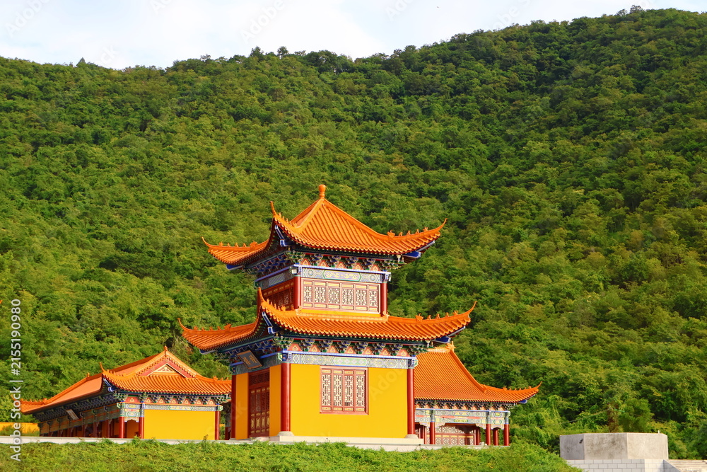 Naklejka premium Traditional Chinese Pagoda Temple Surrounded by Green Mountains in Phnom Sruoch, Kampong Speu, Cambodia