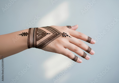 Intricate henna tattoo on woman hand with traditional patterns