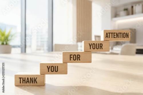 Gratitude Ascent: Wooden blocks spelling THANK YOU FOR YOUR ATTENTION ascend like stairs, symbolizing appreciation and a polite closing in a professional setting.