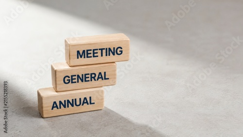 Annual General Meeting Blocks: Wooden blocks stacked to represent Annual, General, and Meeting, symbolizing corporate governance and shareholder gatherings.