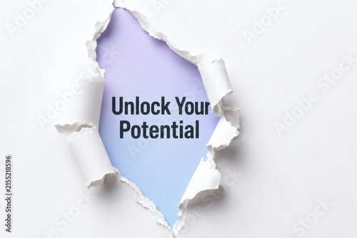 Unlock Your Potential: Torn paper reveals a gradient of blue and purple hues, displaying the empowering message Unlock Your Potential against a backdrop of bright, hopeful light.