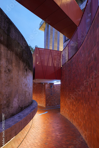 Принти на полотні Curved Red Brick Architectural Passageway in Urban Building