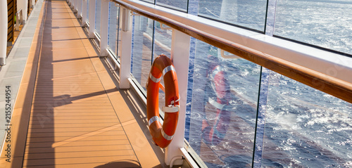 Canvastavla Orange lifebuoy on a deck of cruise ship with ocean on background with copy spac