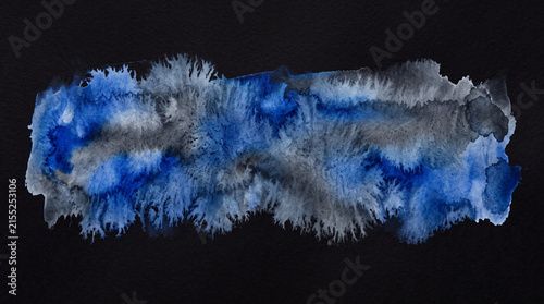 Abstract blue and grey watercolor splash on black background.
