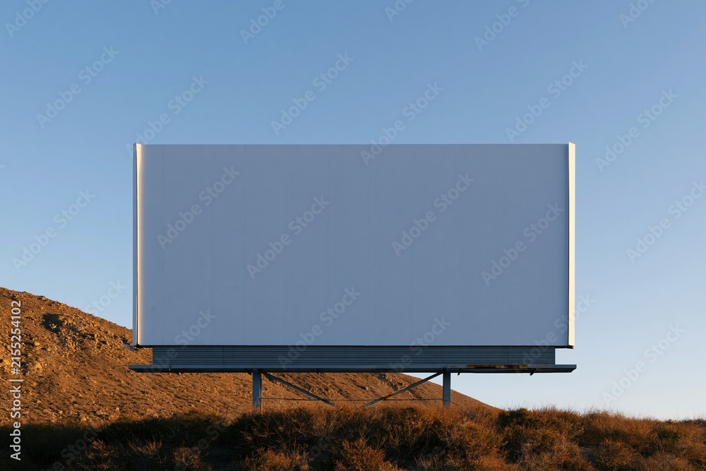 Fototapeta premium Large empty billboard on a steel frame against a mountain ridge, featuring a blank white mockup panel and copy space for outdoor advertising