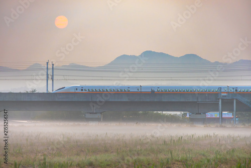 Fotografie High speed passenger train passes through morning mist in Taiwan