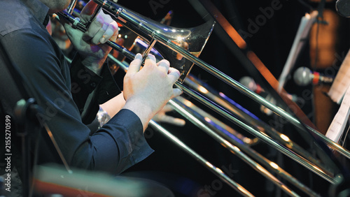 Fotografía Closeup of musician playing trombone during symphony orchestra performance