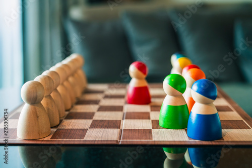 Obraz na plátně Wooden figures on chessboard facing each other in strategy board game, concept for business competition, team leadership, diversity, decision making, choice, and strategic plan