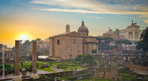 Fotografie Roman Forum and Curia Julia in Rome against dramatic golden sunrise with copy sp