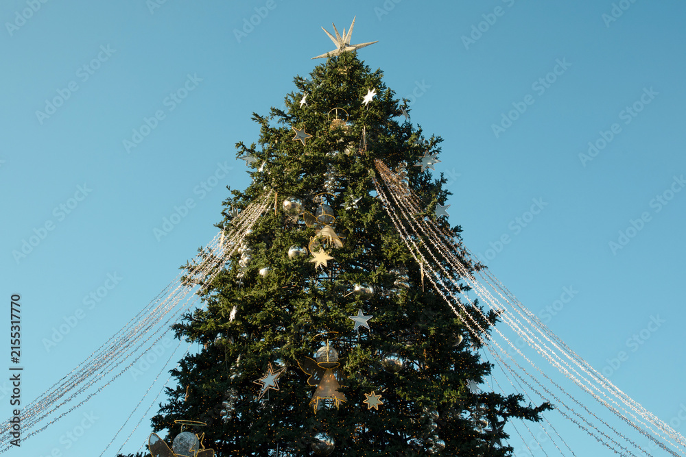 Obraz premium Christmas. Beautiful Christmas tree with ornaments and lights in outdoor space