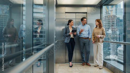 Modern office interior with glass walls and employees walking in hallway