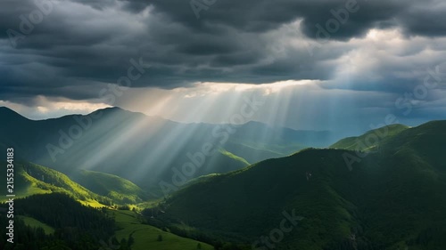 Sunlight breaks through dark storm clouds over a lush green mountain landscape.