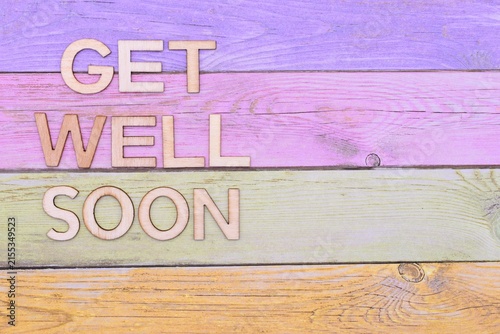get well soon write on rustical wooden background - greeting card background 