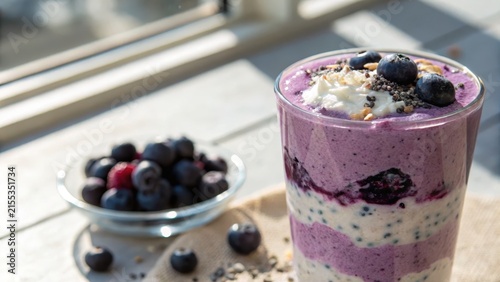 Creamy blueberry smoothie layered with whipped cream and chia seeds