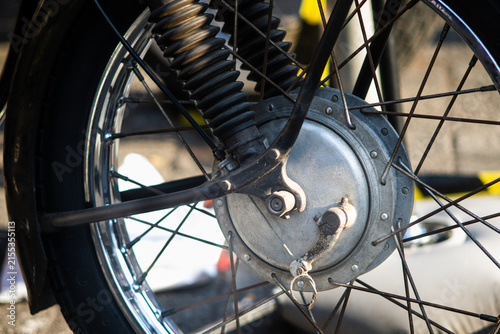 Close Up View of Classic Motorcycle Front Wheel with Spoke Rim and Drum Brake Hub