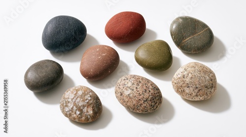 Collection of Smooth, Varied Pebbles and Stones on a White Background.