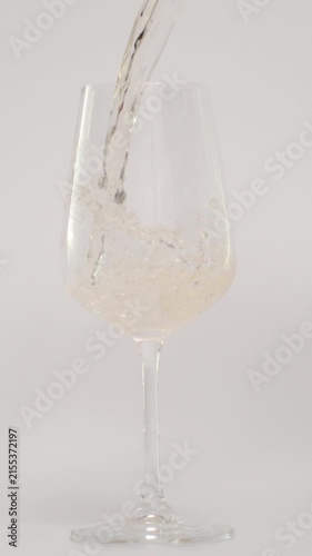 Slow Motion of Pouring Wine in Tilted Glass at 1000 fps, White Background, Vertical Video