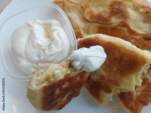 Bild auf Leinwand Cut-open homemade pie revealing savory potato and mushroom filling, rustic traditional food