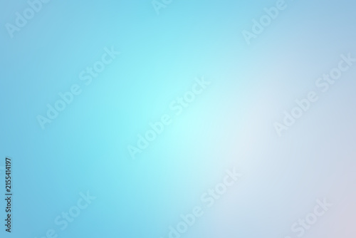 Abstract background of light blue shades with glare and bokeh effect.