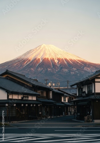 Majestic Mount Fuji at Sunset with Traditional Japanese Village Below.