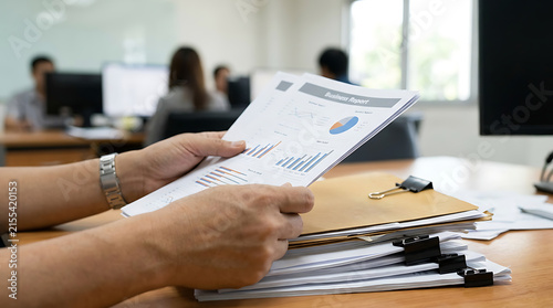 Business Professional Reviewing Financial Report with Charts and Graphs in Modern Office, Corporate Data Analysis, Finance, Planning and Strategy Concept
