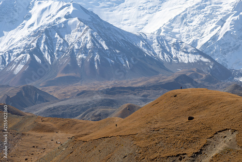 Photography Tiny silhouettes of trekkers on high-altitude hills highlighting huge scale of P